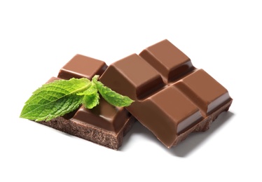 Photo of Pieces of milk chocolate with mint on white background