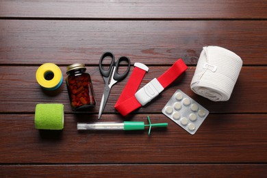 Photo of Flat lay composition with medical tourniquet on wooden table