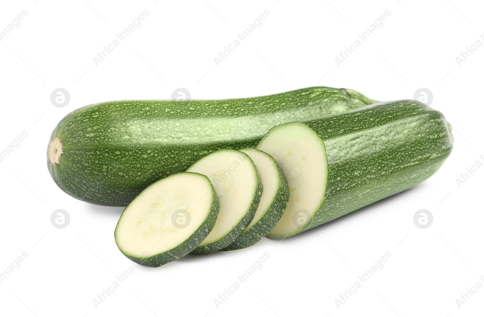 Photo of Whole and cut ripe zucchinis on white background