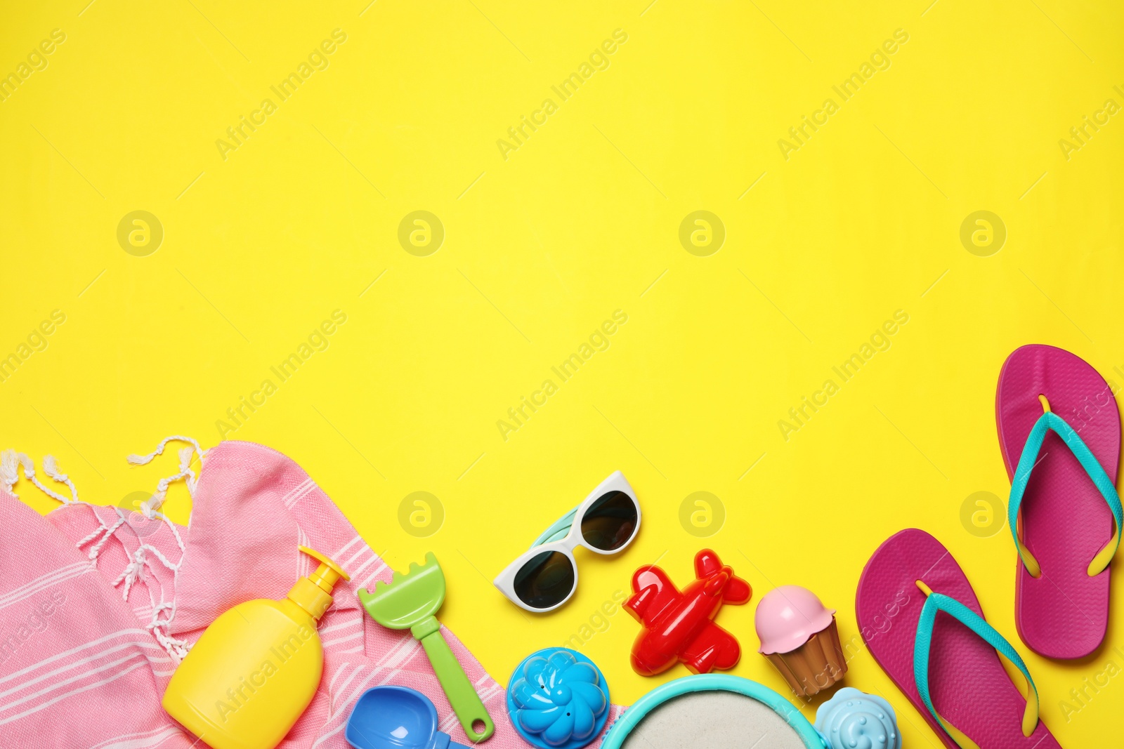 Photo of Flat lay composition with beach toys on color background. Space for text