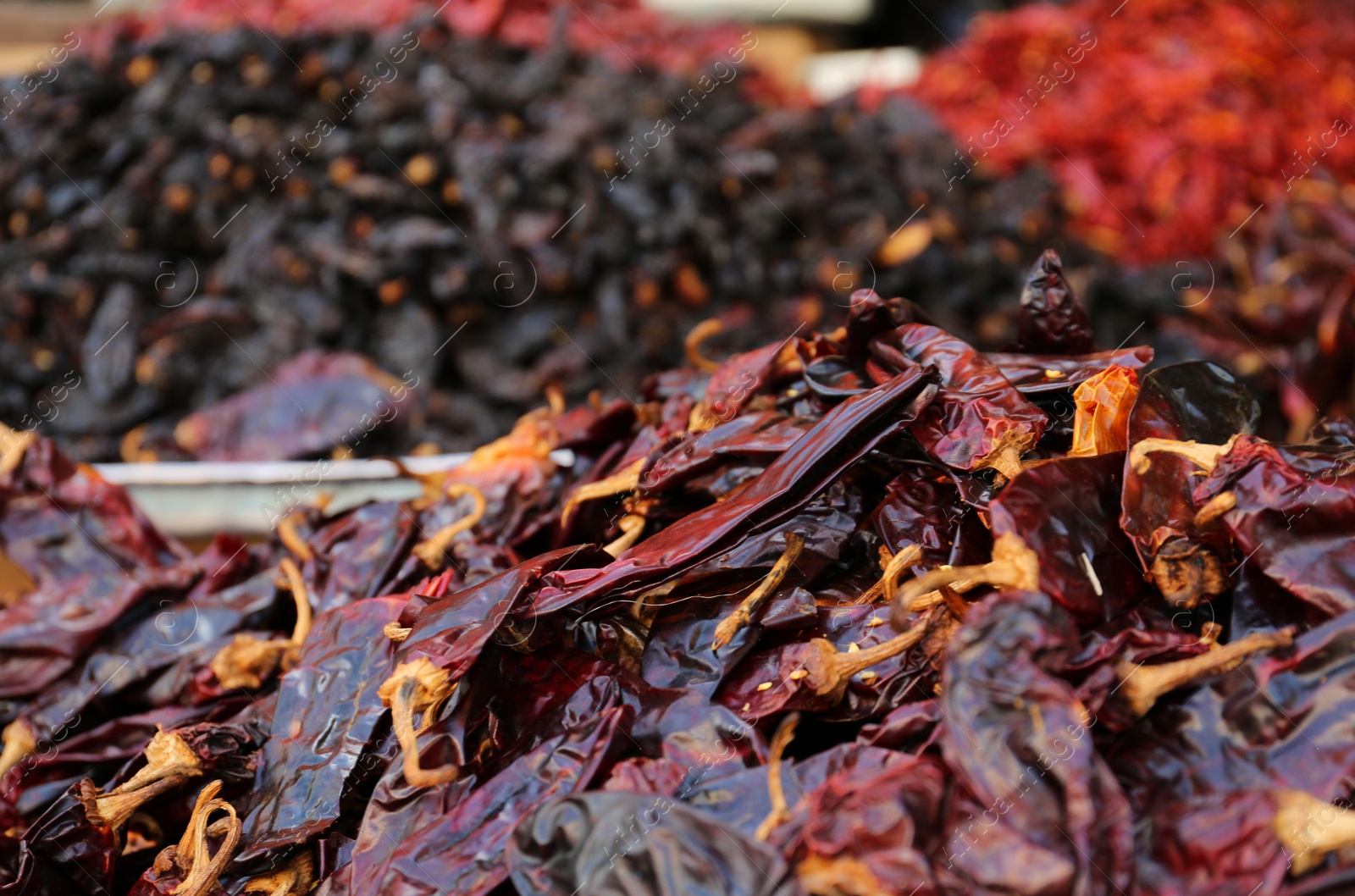 Photo of Heap of dried Serrano peppers on counter at market, closeup. Space for text