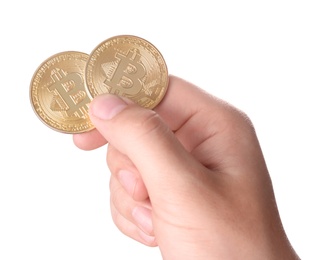 Photo of Man holding golden bitcoins on white background, closeup