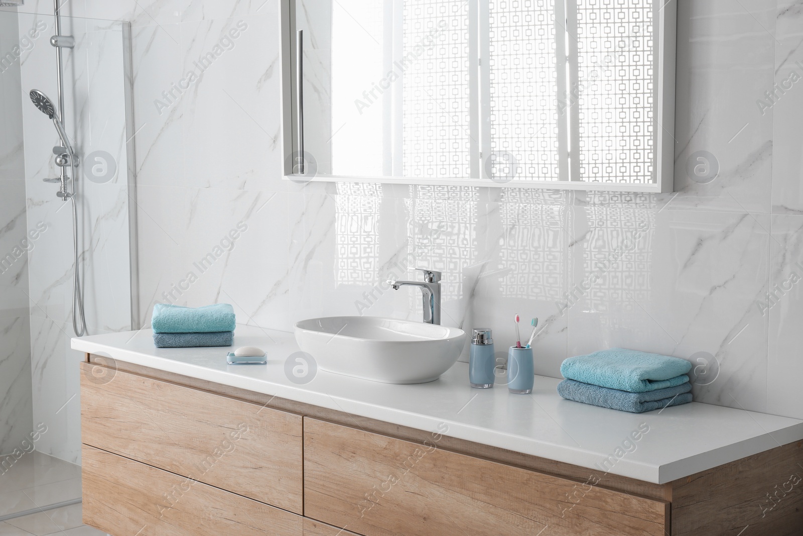 Photo of Modern mirror and vessel sink in stylish bathroom