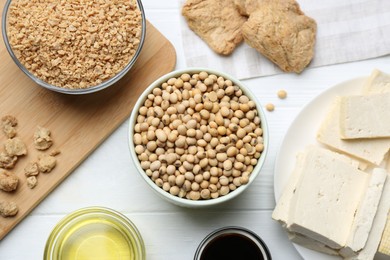 Different natural soy products on white wooden table, flat lay