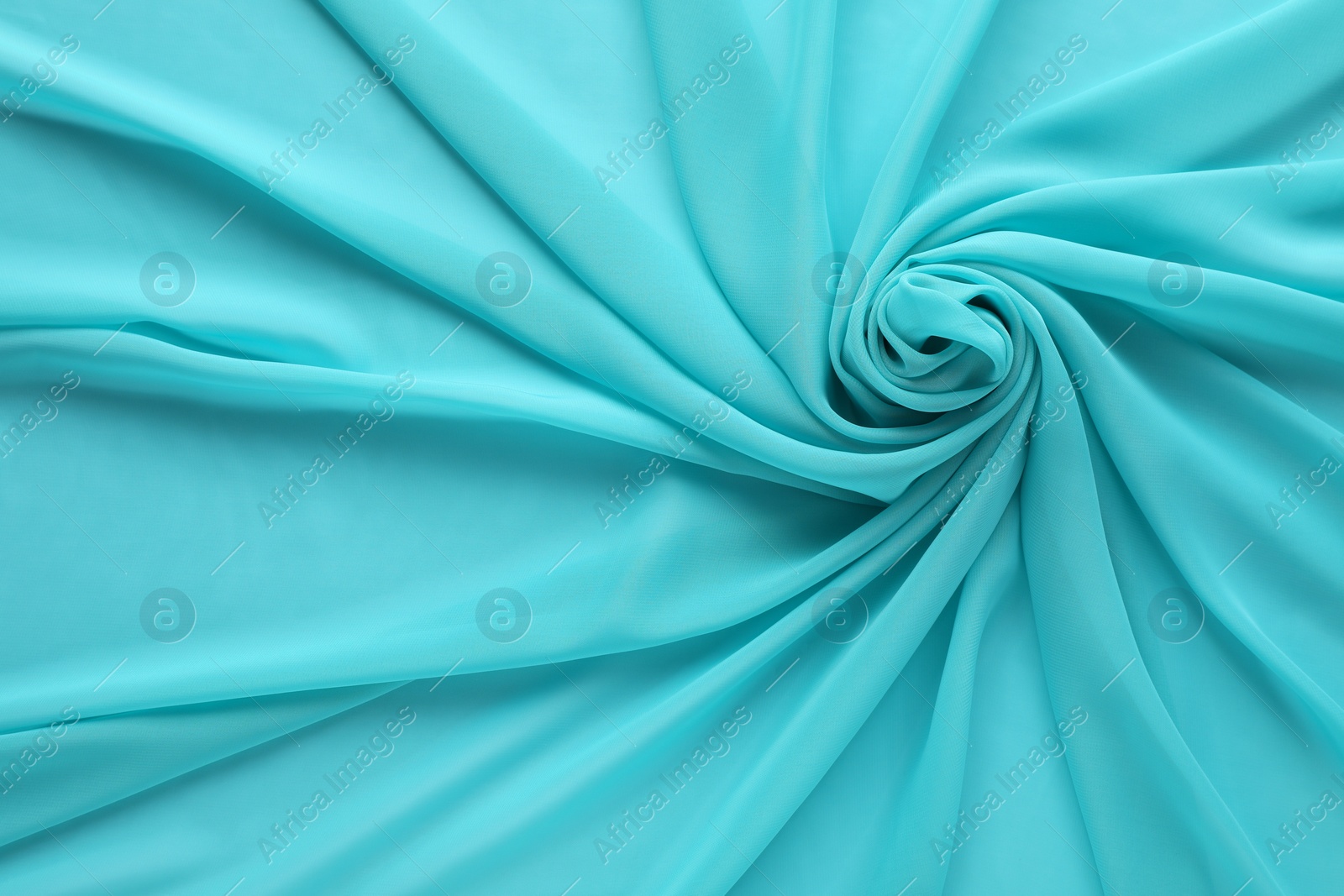 Photo of Beautiful turquoise tulle fabric as background, top view