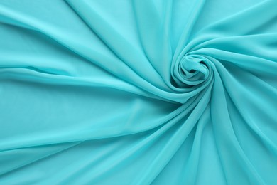 Beautiful turquoise tulle fabric as background, top view