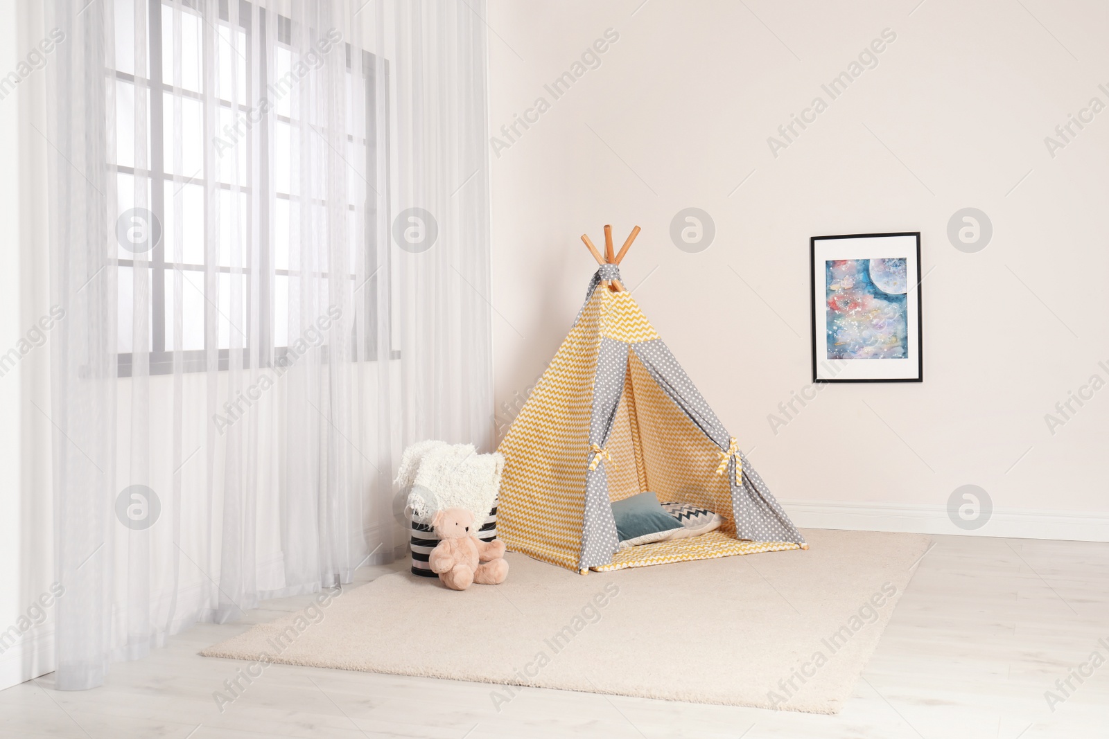 Photo of Cozy child room interior with play tent near window