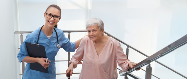 Doctor helping senior patient in modern hospital. Banner design