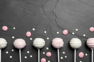 Photo of Flat lay composition with sweet cake pops on black background. Space for text