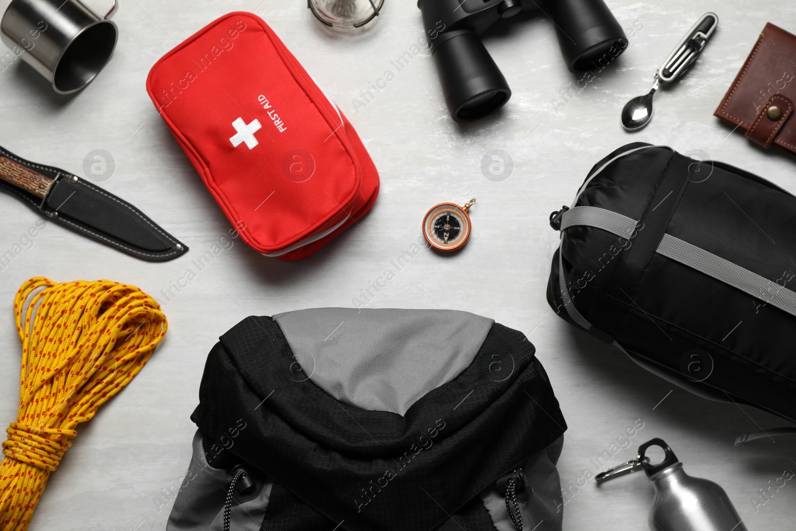 Flat lay composition with different camping equipment on light background Photo of Flat lay composition with different camping equipment on light background