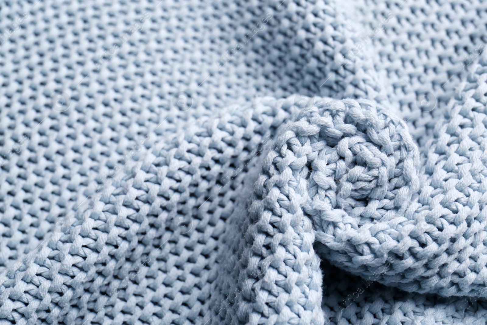 Photo of Beautiful light blue knitted fabric as background, top view