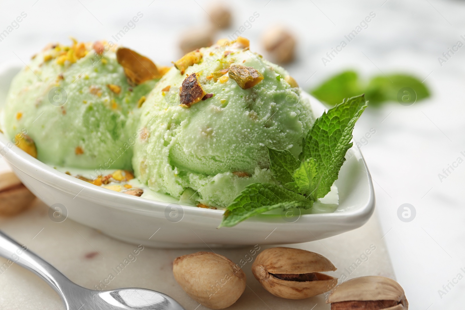 Photo of Delicious pistachio ice cream served on table, closeup