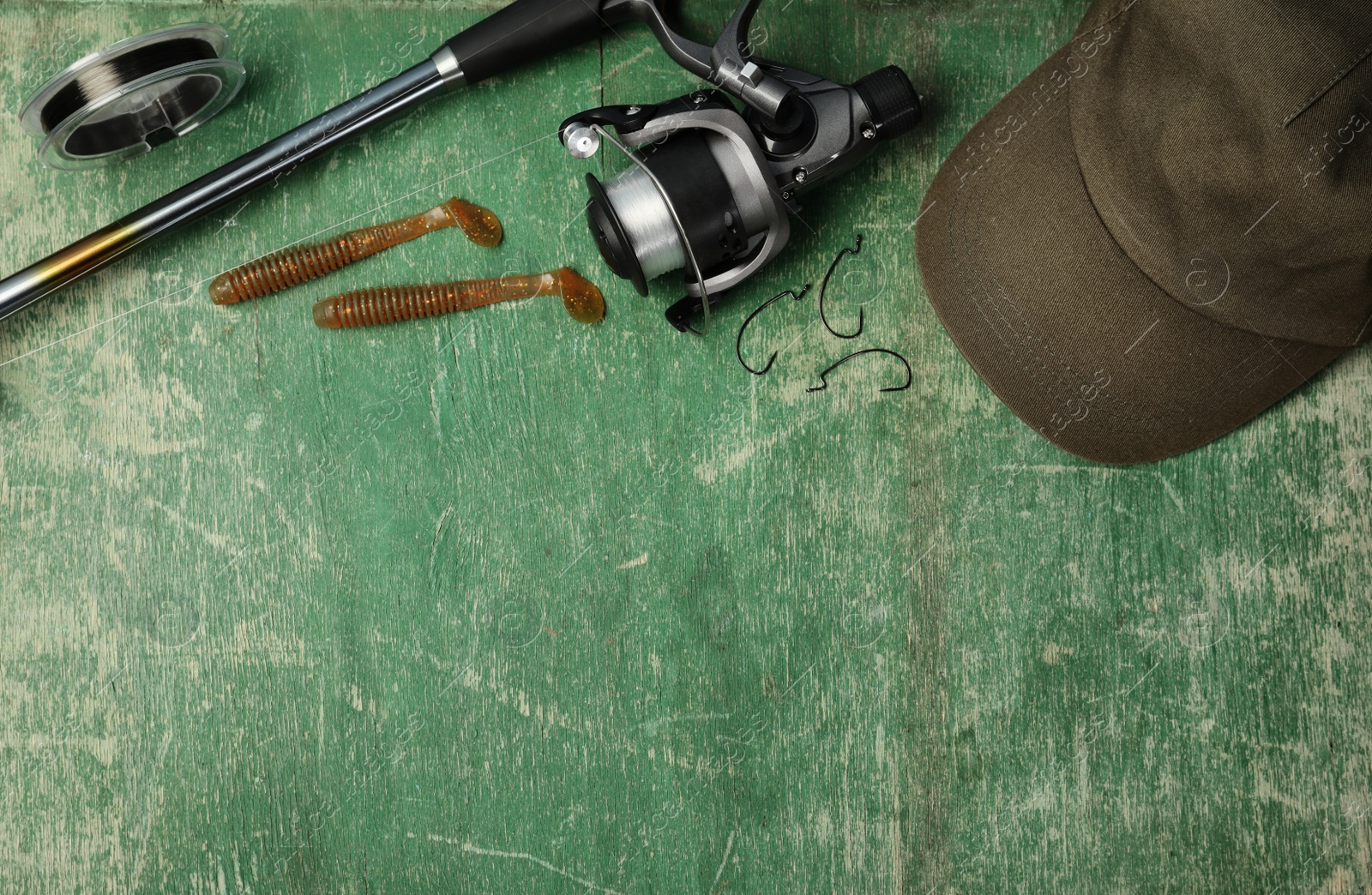 Photo of Flat lay composition with fishing equipment and space for text on wooden background