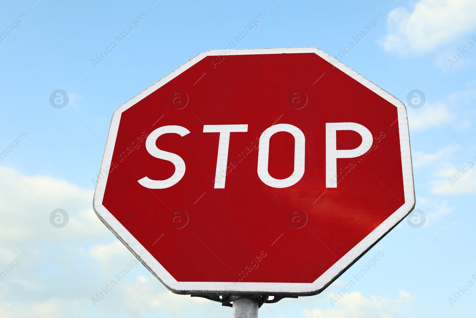 Photo of Traffic sign Stop against blue sky, low angle view