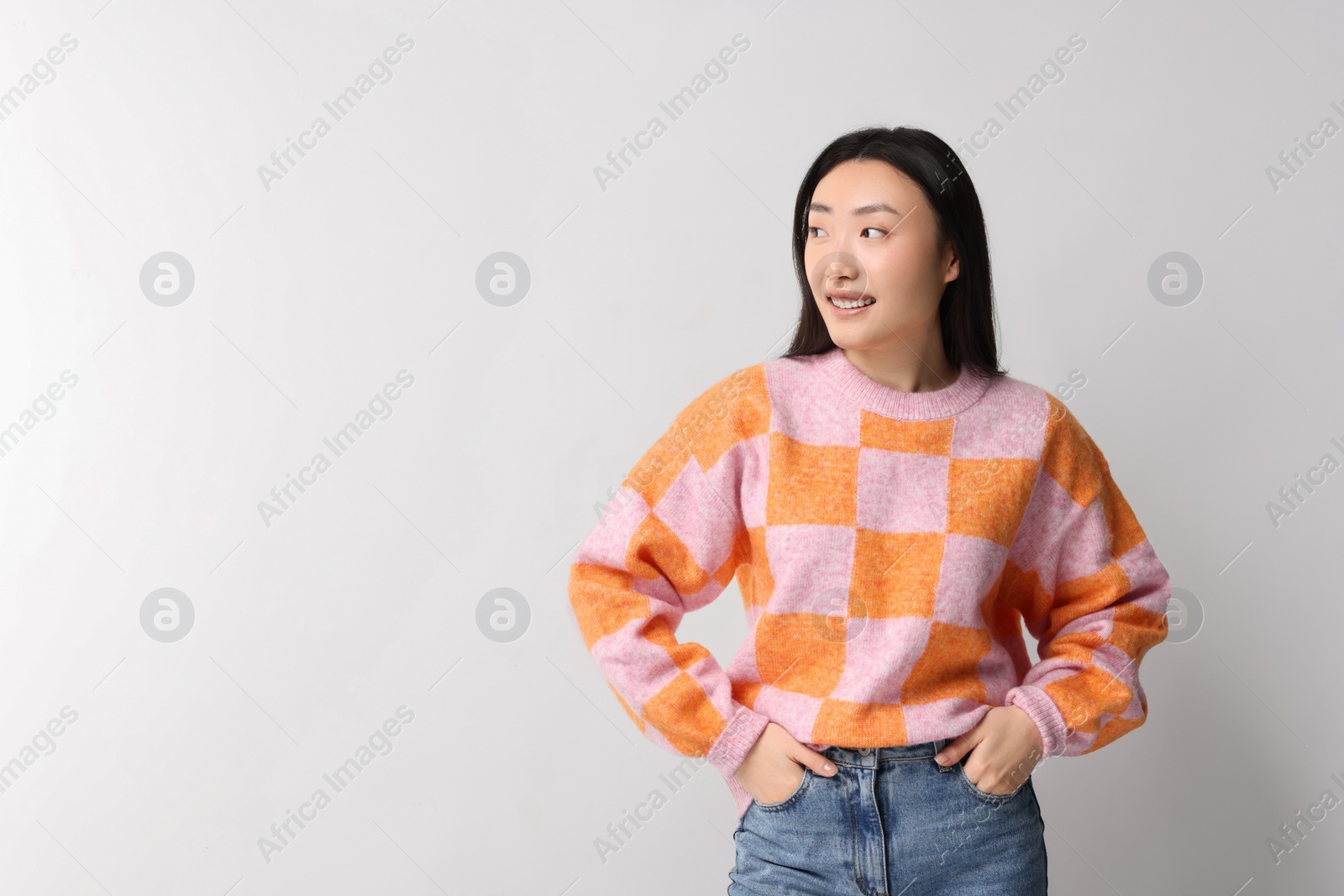 Photo of Portrait of smiling woman on light background. Space for text