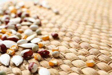 Mixed vegetable seeds on wicker background, closeup