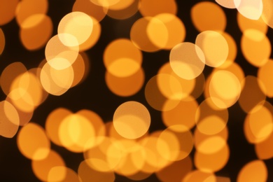 Beautiful golden lights on dark background. Bokeh effect