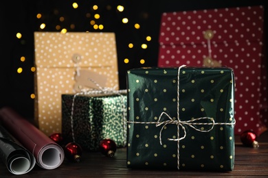 Photo of Composition with beautifully wrapped gift box on wooden table