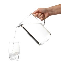 Photo of Woman pouring water from jug into glass on white background, closeup