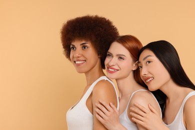 Portrait of beautiful young women on beige background. Space for text