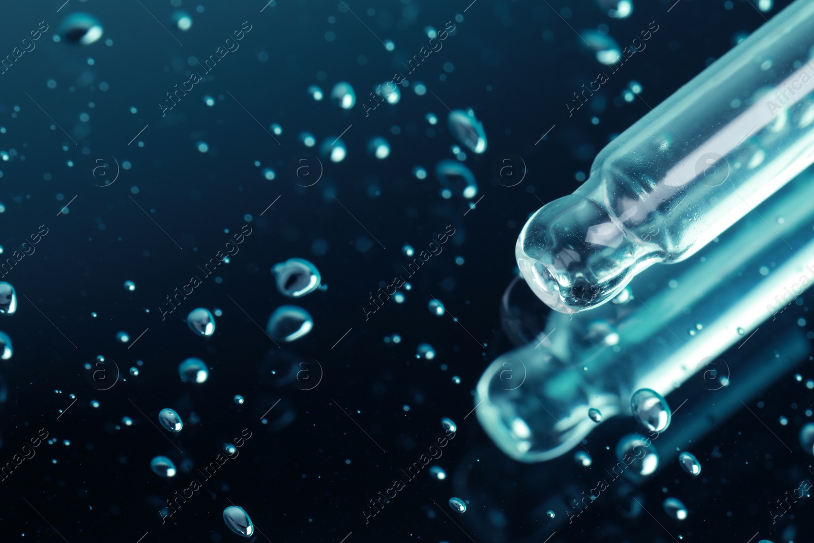 Photo of Pipette and serum drops on mirror, closeup with space for text. Color tone effect