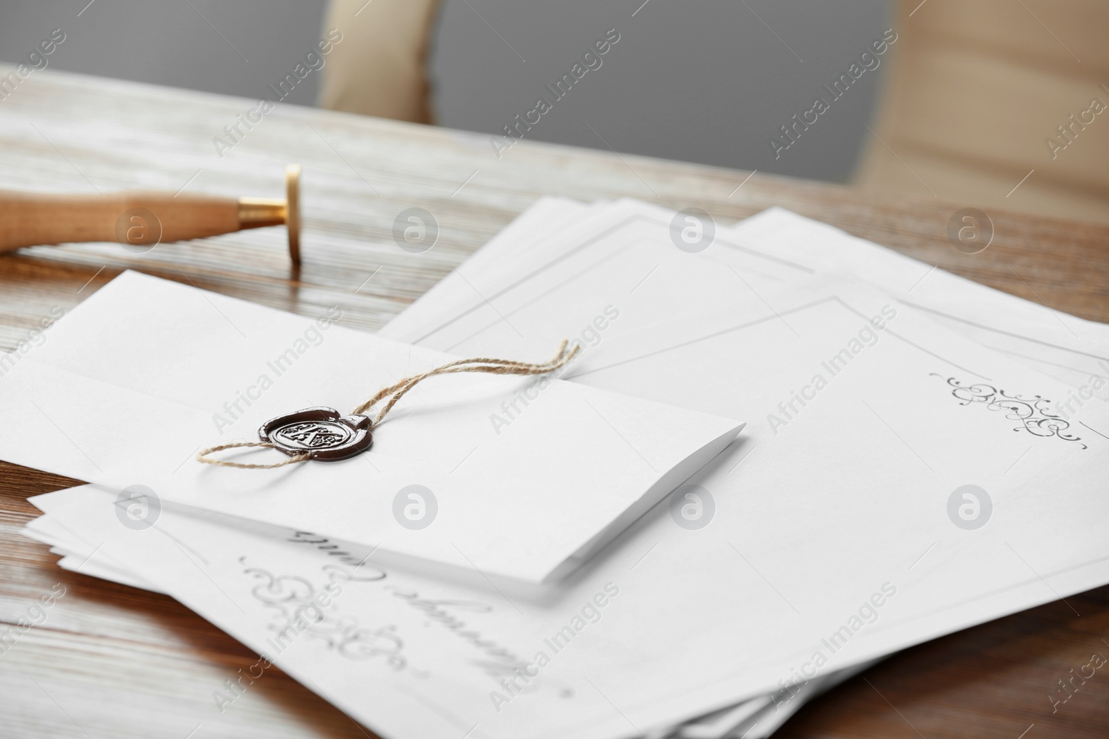 Photo of Document with notary seal and papers on wooden table in office