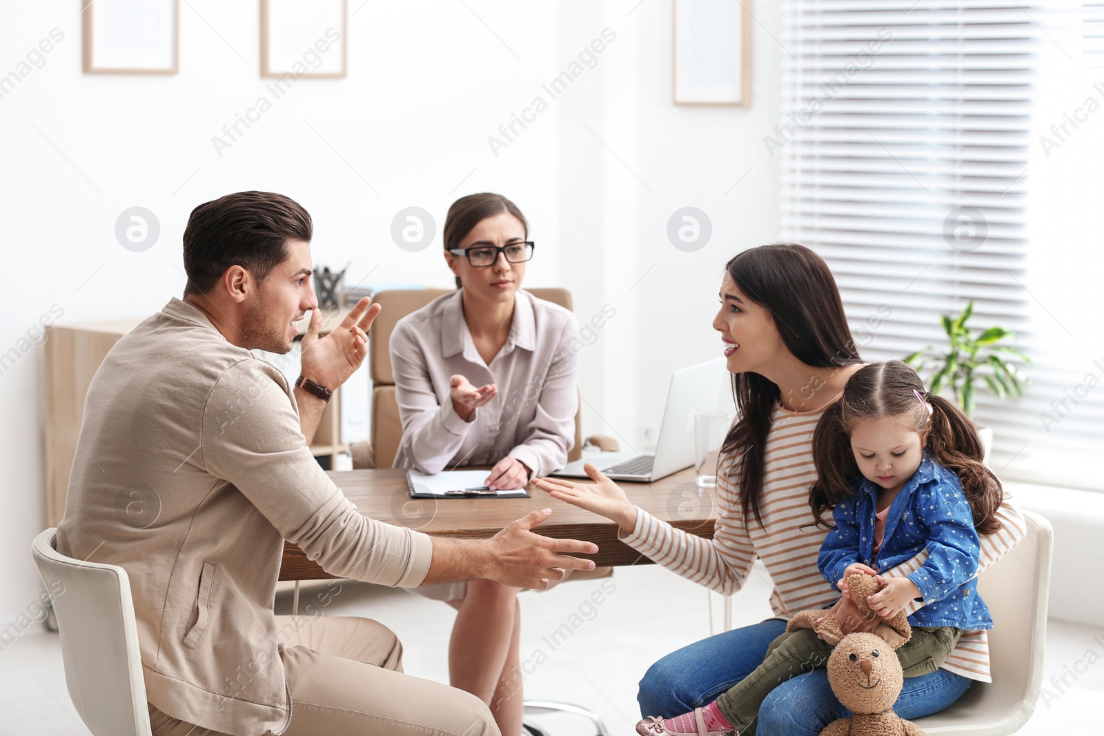 Photo of Professional psychologist working with family in office