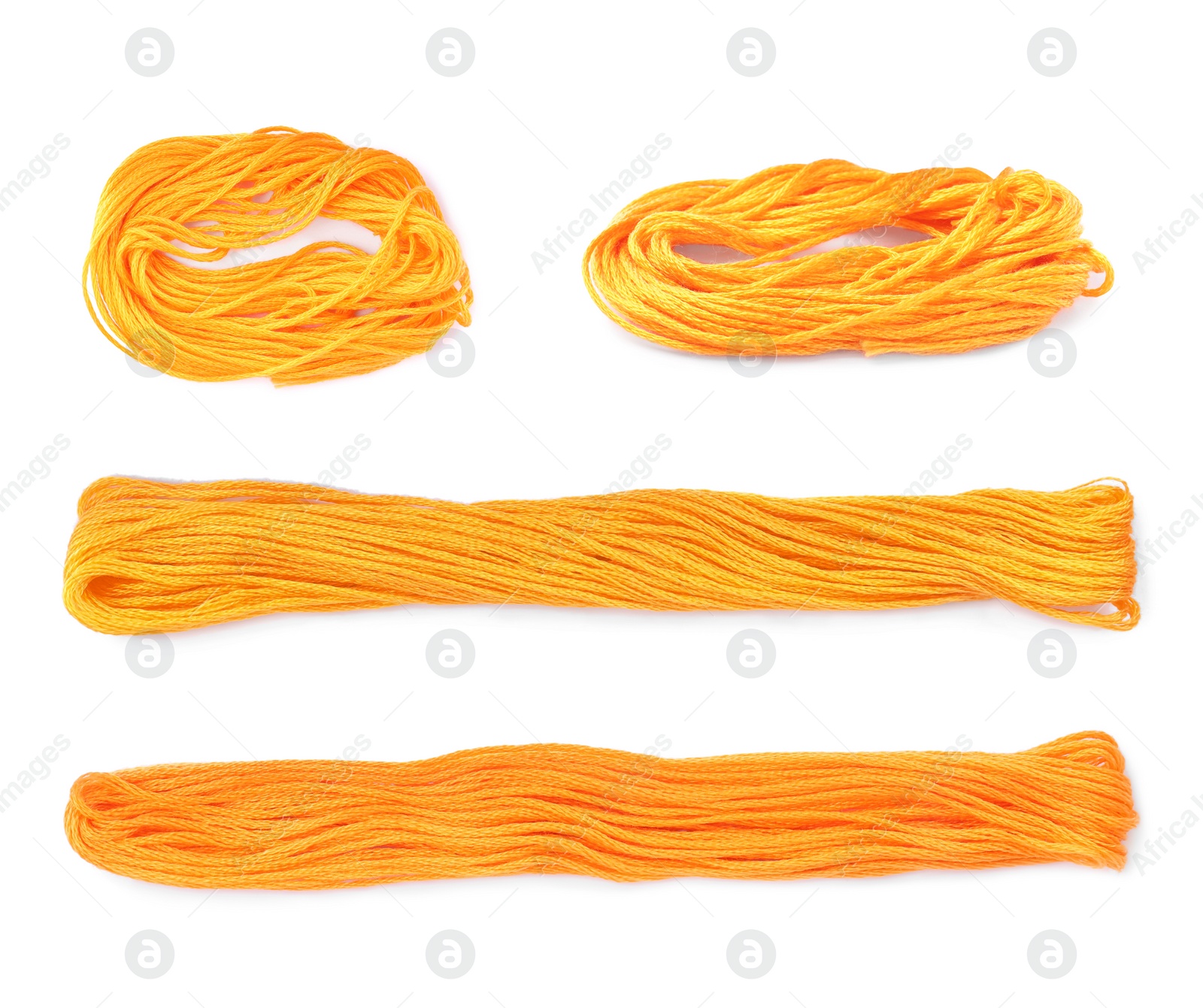 Image of Set with orange embroidery threads on white background