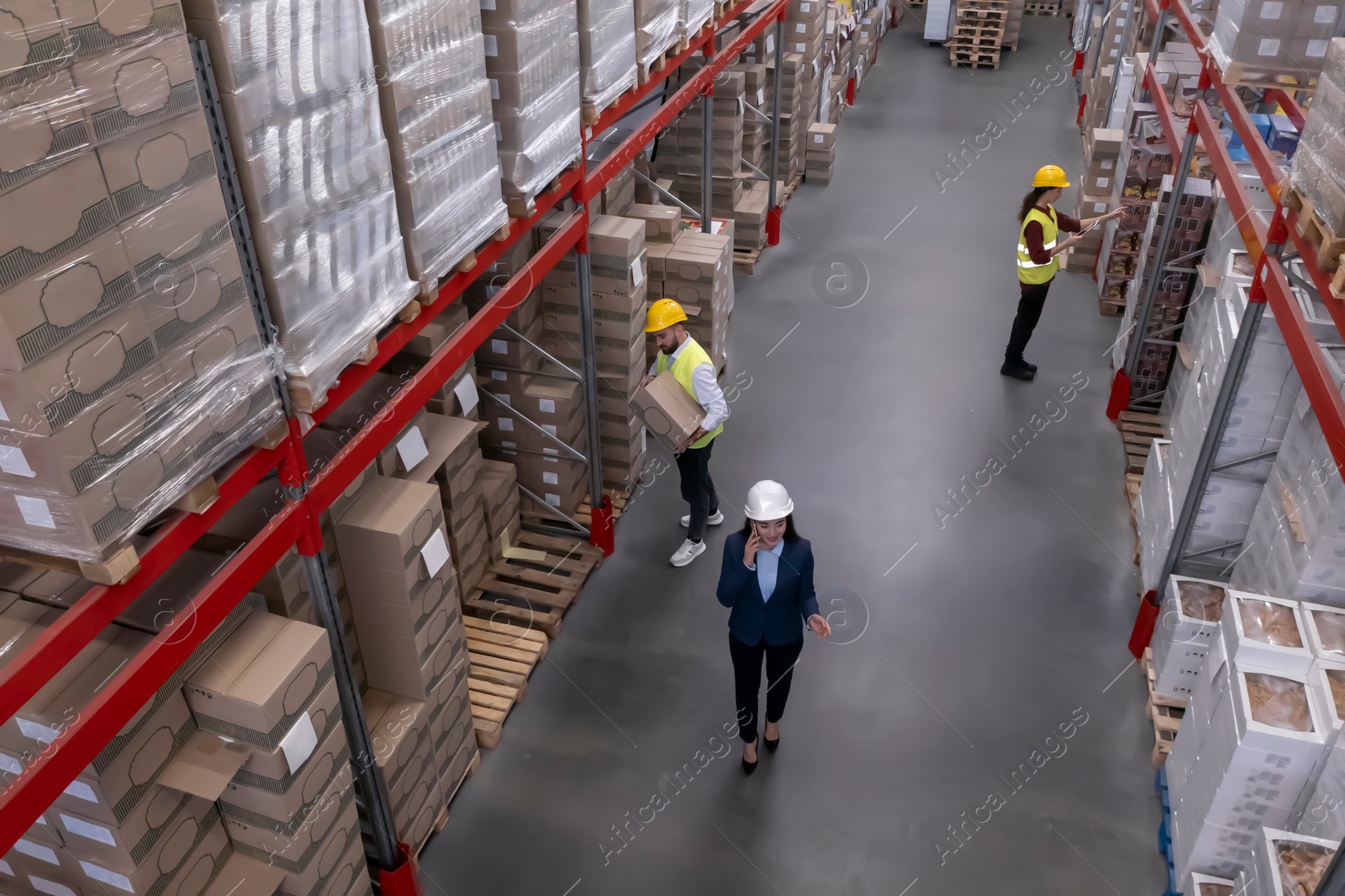 Image of Manager and workers at warehouse, above view. Logistics center