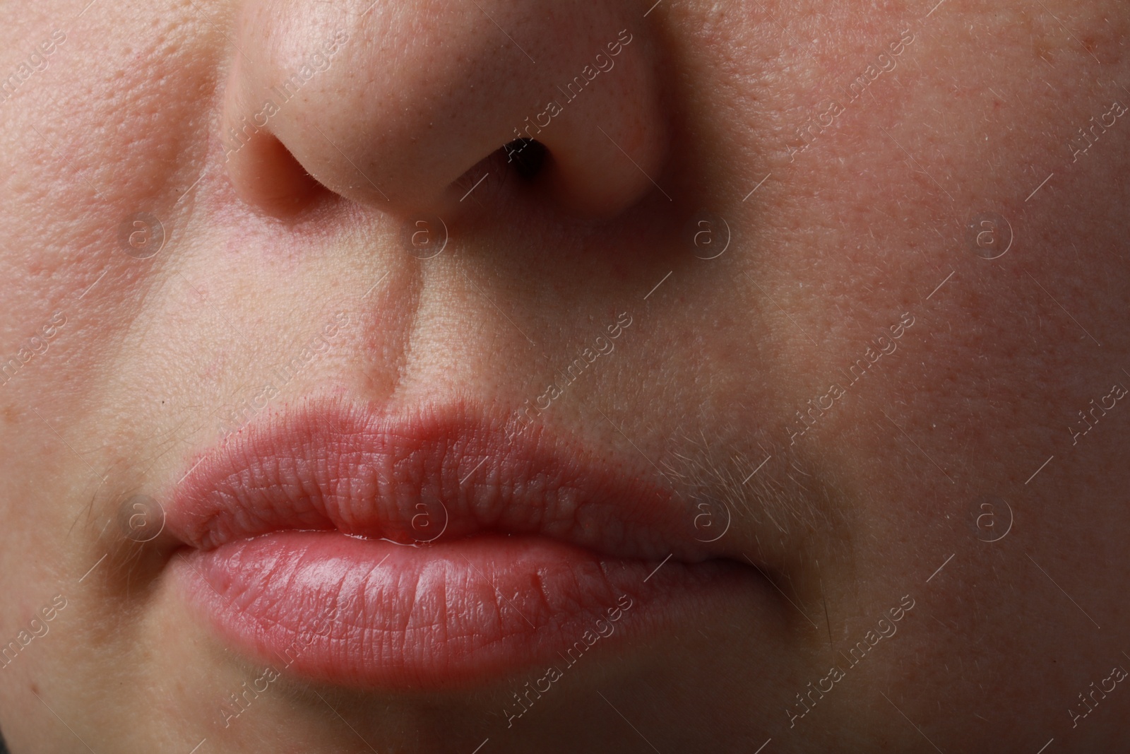 Photo of Closeup view of woman with normal skin and beautiful lips