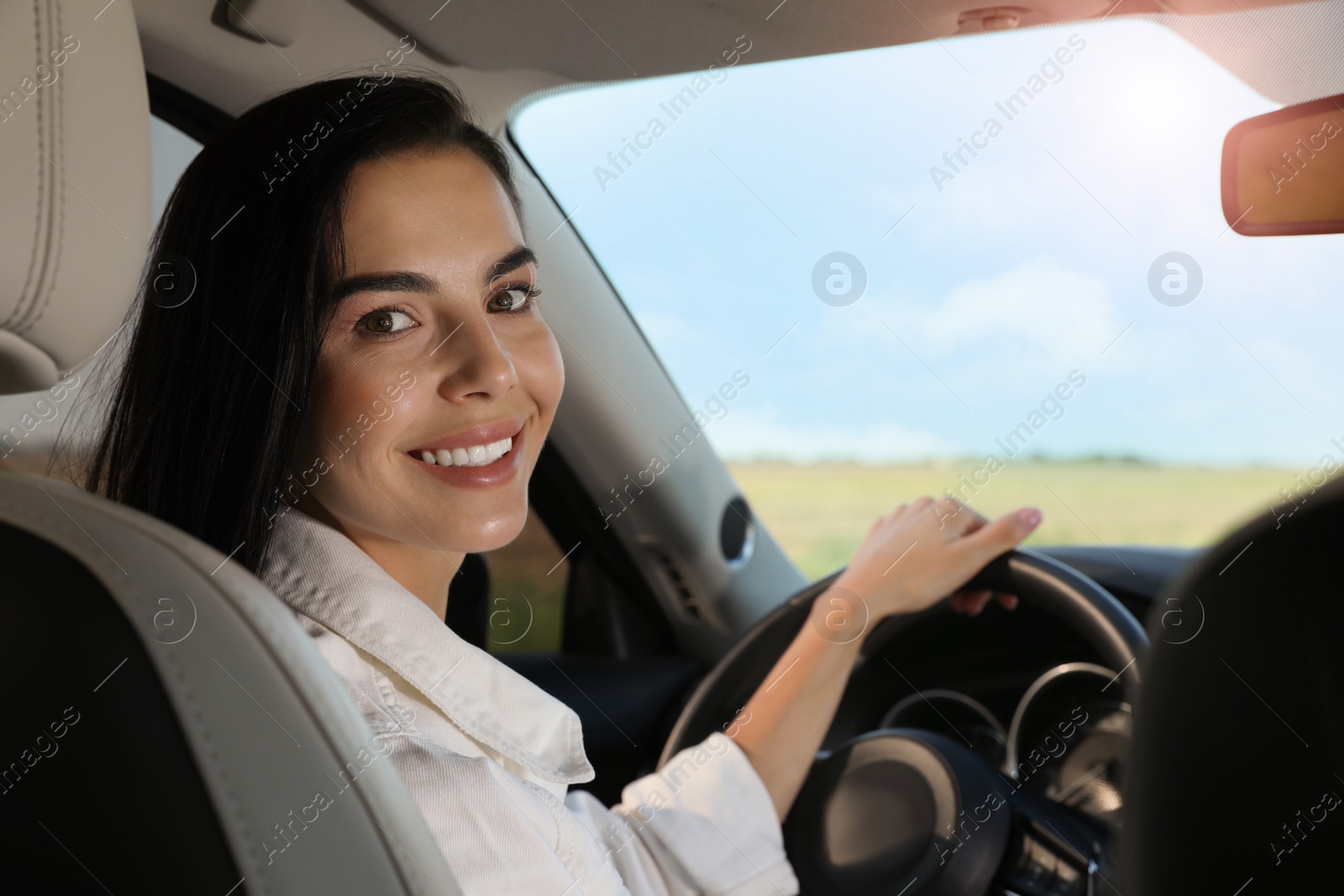 Photo of Beautiful young woman on driver's seat in modern car