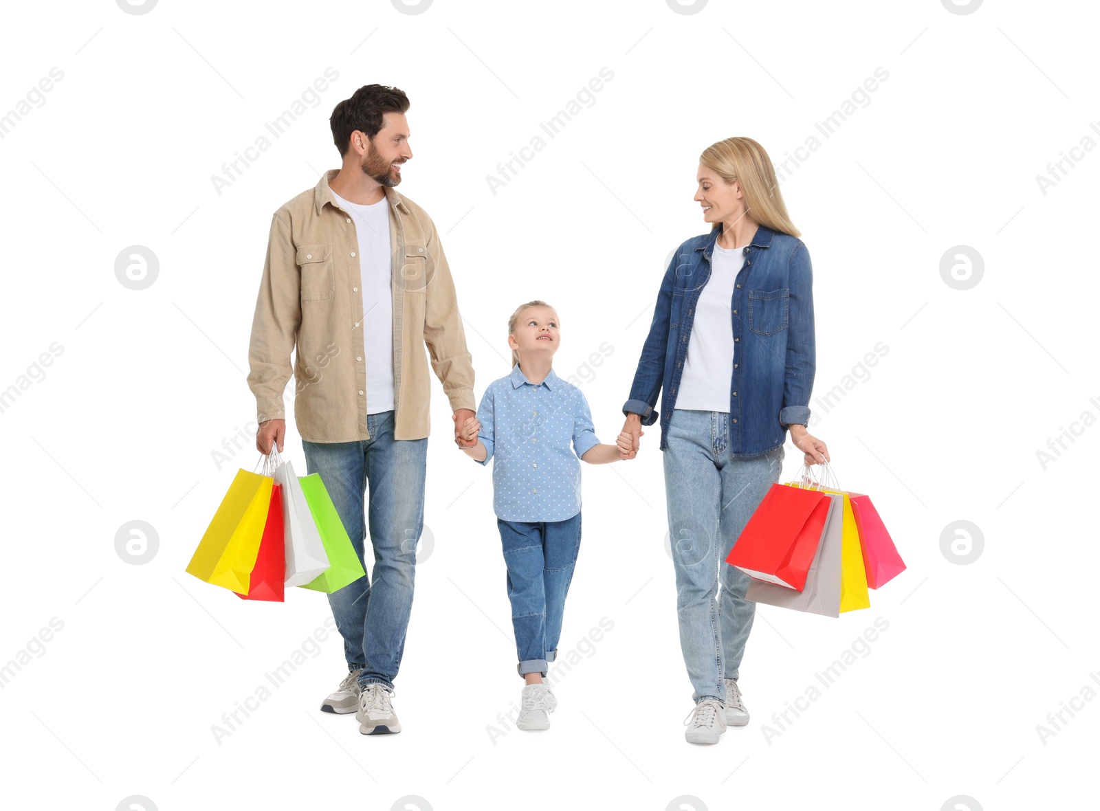 Photo of Family shopping. Happy parents and daughter with many colorful bags on white background