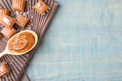 Salted caramel on blue wooden table, top view. Space for text