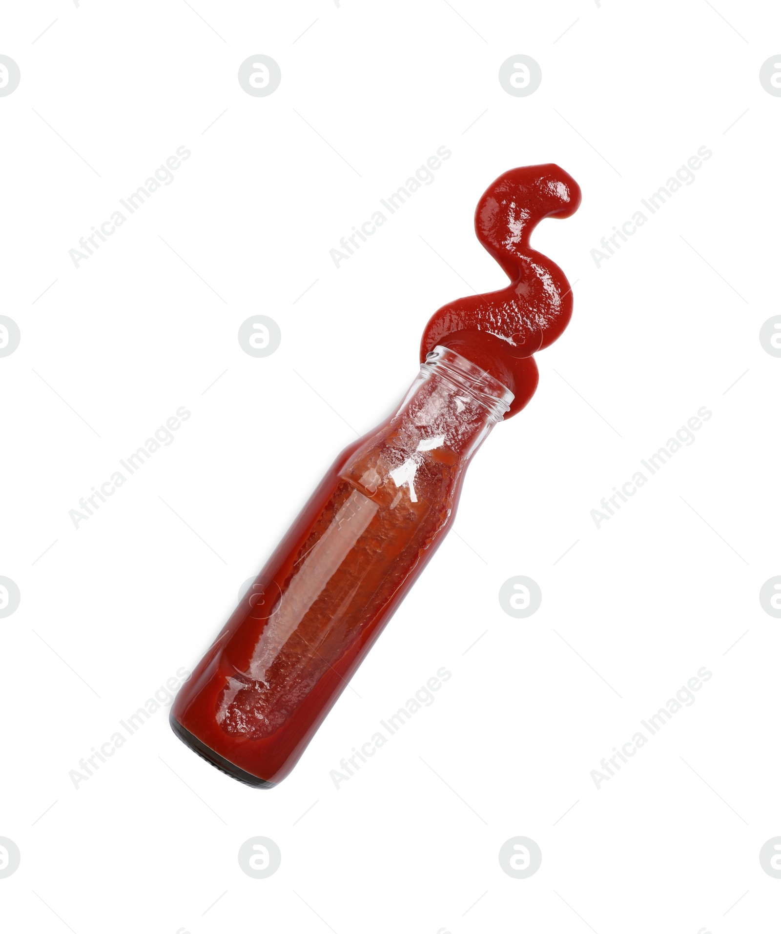 Photo of Ketchup and glass bottle isolated on white, top view