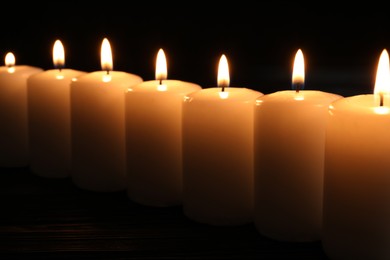 Photo of Burning candles on dark background. Memory day