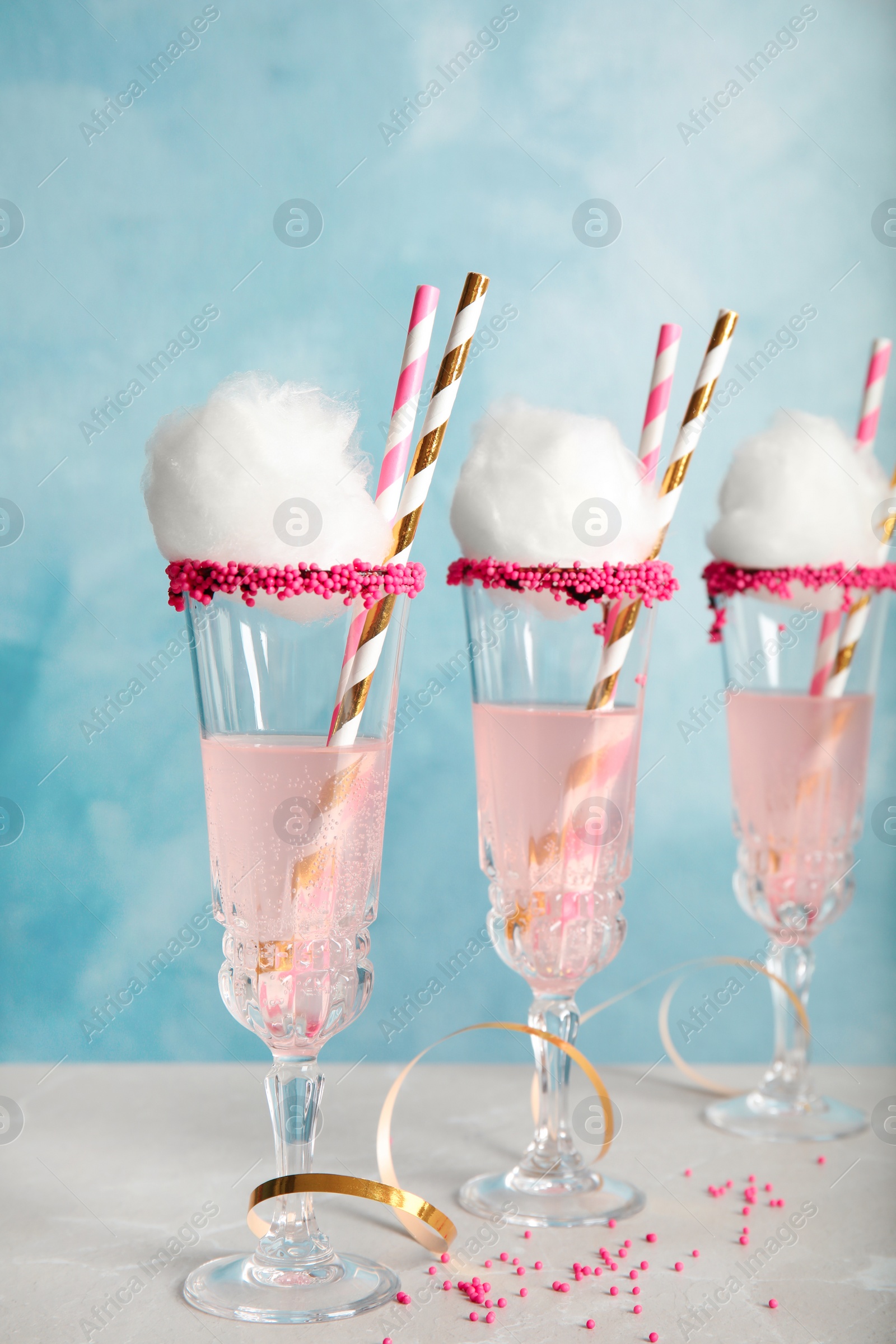 Photo of Cocktail with cotton candy in glasses on table