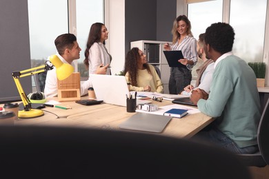 Photo of Team of employees working together in office. Startup project