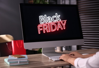 Photo of Woman shopping online using computer in office, closeup. Black Friday Sale