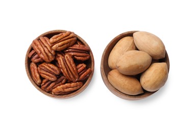 Photo of Tasty pecan nuts in bowls isolated on white, top view