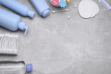 Photo of Flat lay composition with baby care products on grey table, space for text