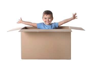 Photo of Cute little boy playing with cardboard box on white background