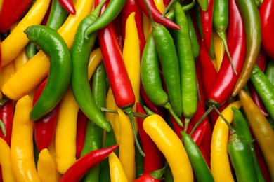 Ripe hot chili peppers as background, closeup