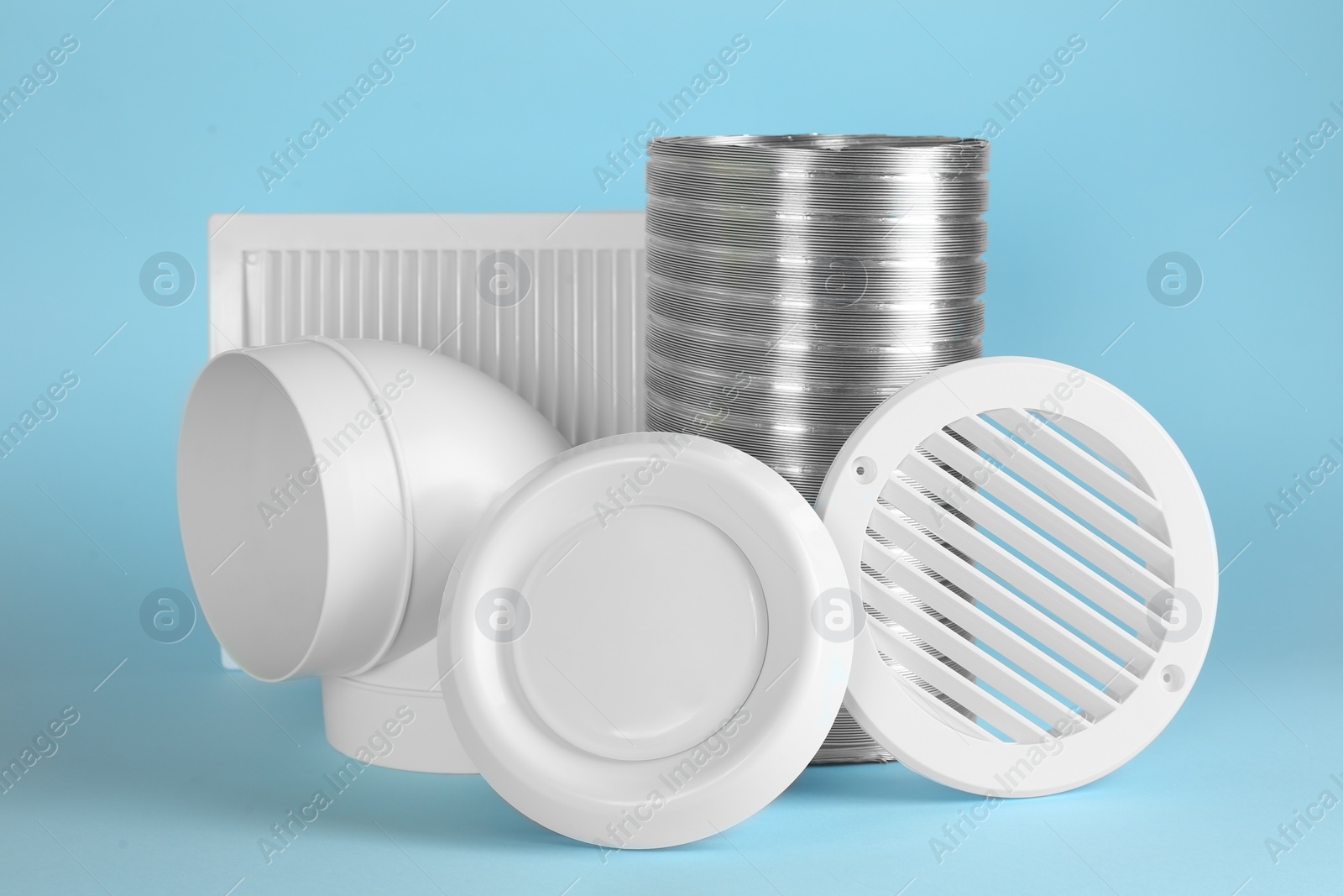 Photo of Parts of home ventilation system on light blue background