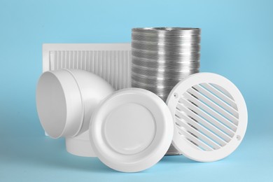 Parts of home ventilation system on light blue background