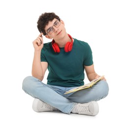Photo of Portrait of student with notebook and headphones sitting on white background