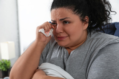 Photo of Overweight woman suffering from depression at home