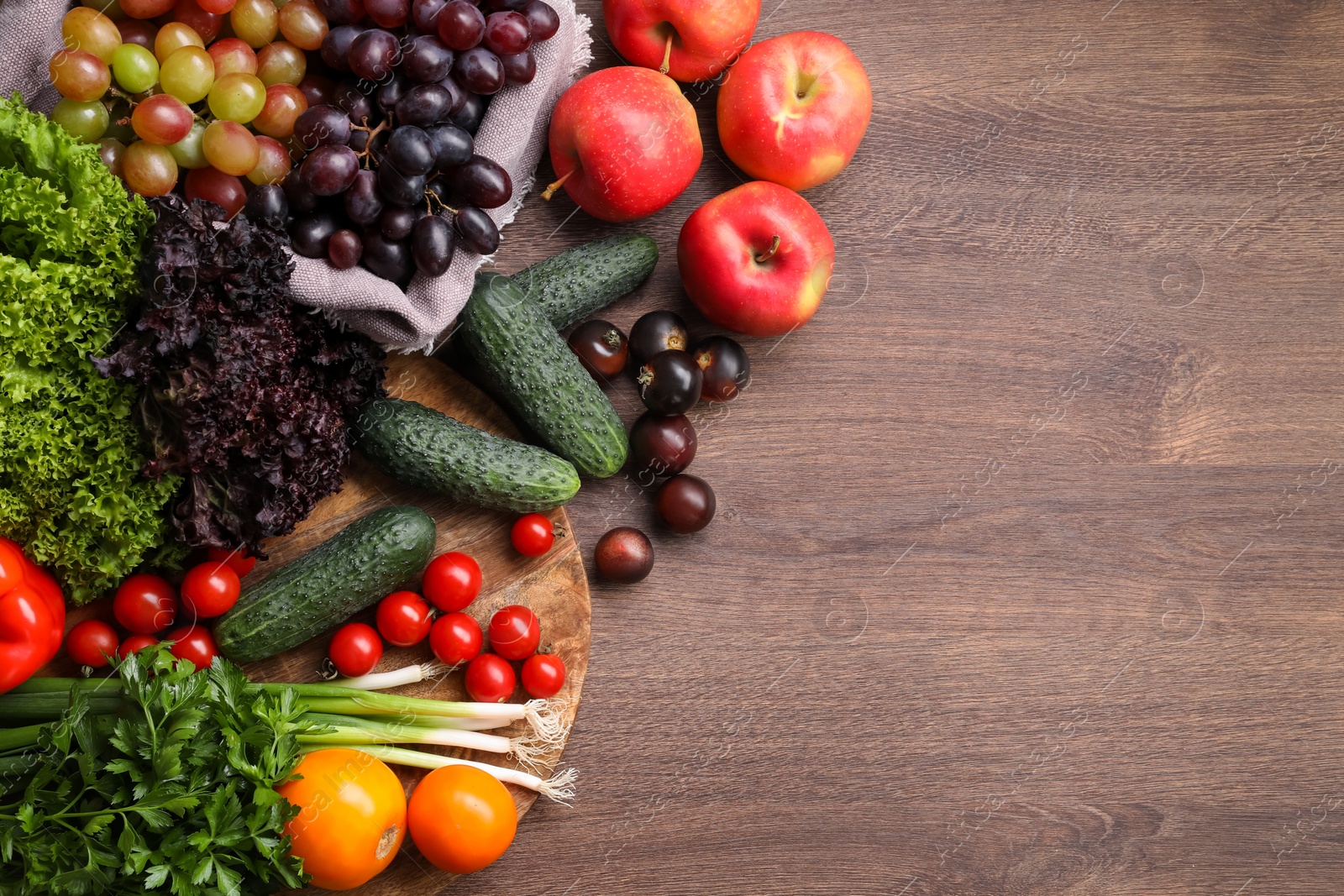 Photo of Different fresh ripe vegetables and fruits on wooden table, flat lay. Space for text