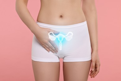 Image of Woman in underwear and illustration of reproductive system on pink background, closeup