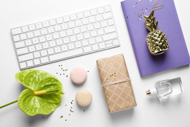 Photo of Creative flat lay composition with tropical flower, gift box and computer keyboard on white background