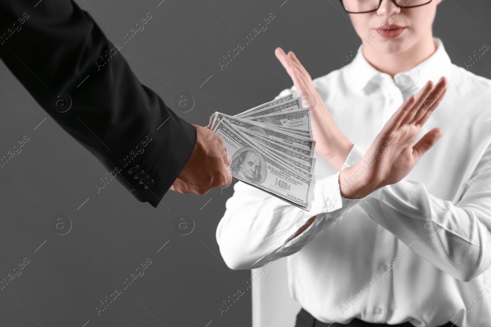Photo of Woman refuses to take bribe money on dark background, closeup